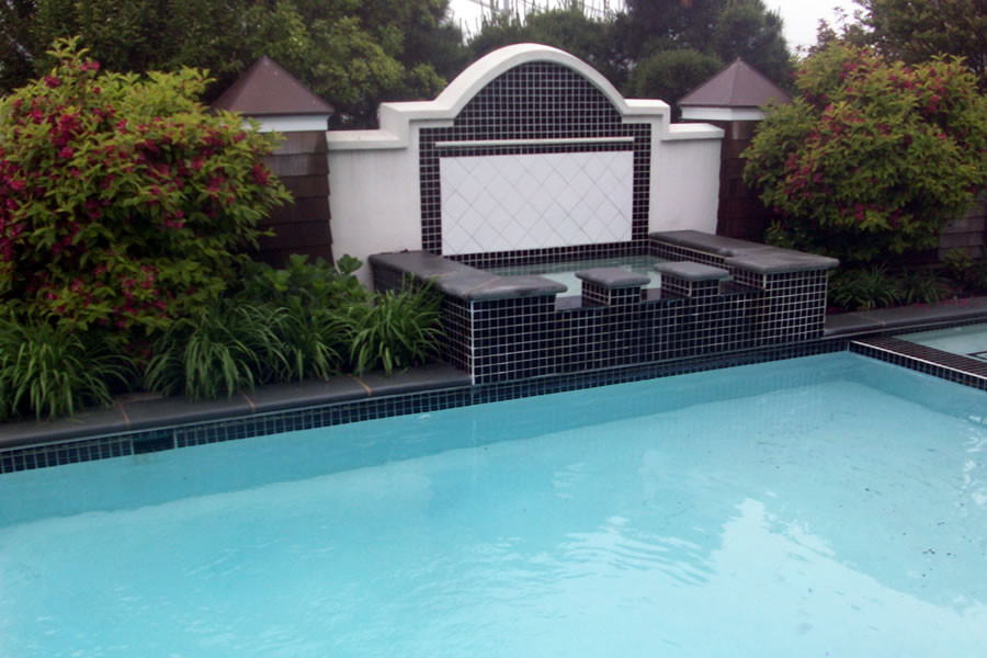 Outdoor Pool and Spa with Water Feature and Pool CoverResidential Pool Design by Omega Pool Structures, Inc
