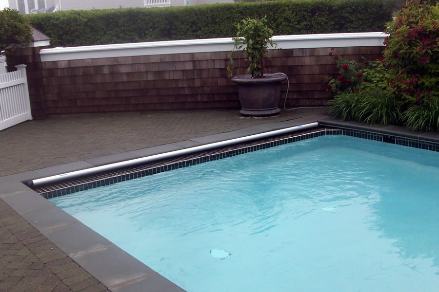 Outdoor Pool and Spa with Water Feature and Pool CoverResidential Pool Design by Omega Pool Structures, Inc